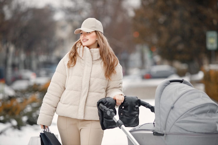blonde-woman-with-baby-stroller-walking-city-with-shopping-packages_690749-345