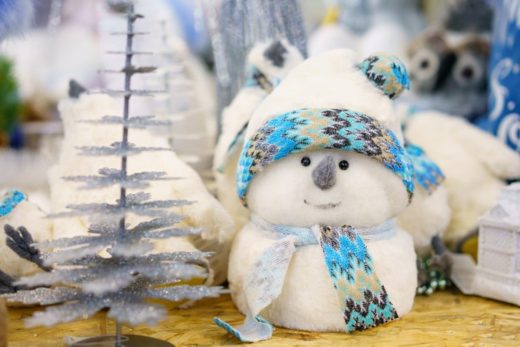 christmas-decoration-toy-white-snowman-made-cotton-wool-with-blue-scarf-shelf-store_78492-3903