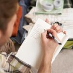 close-up-portrait-man-going-through-checklist-packing-holiday-looking-items-he-wants_1258-270242