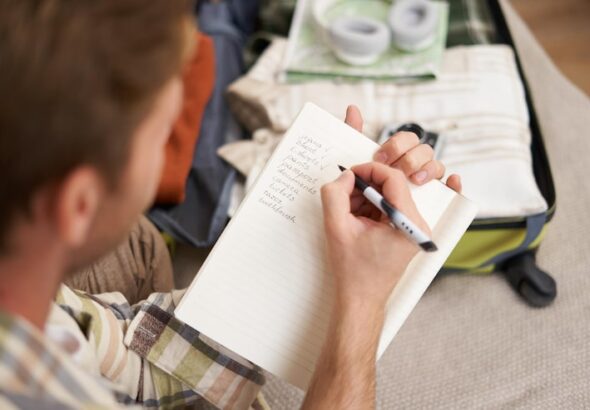 close-up-portrait-man-going-through-checklist-packing-holiday-looking-items-he-wants_1258-270242