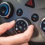 cropped-hand-adjusting-air-conditioner-car_11304-3763