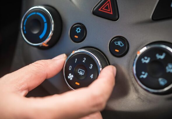 cropped-hand-adjusting-air-conditioner-car_11304-3763