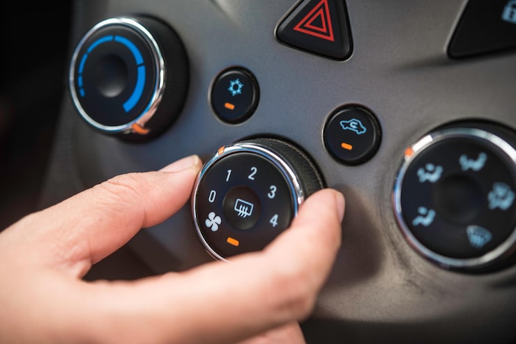 cropped-hand-adjusting-air-conditioner-car_11304-3763