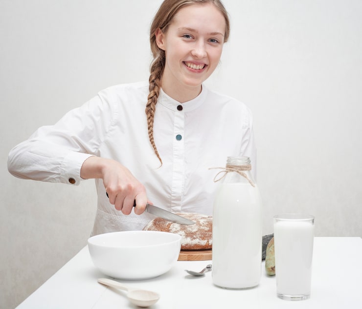 cute-girl-having-breakfast-white-table_23-2148399128