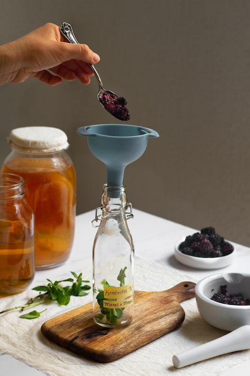 delicious-blackberries-kombucha-bottle-still-life_23-2150252139