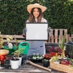 female-gardener-standing-potted-plants-showing-white-frame_23-2148165229