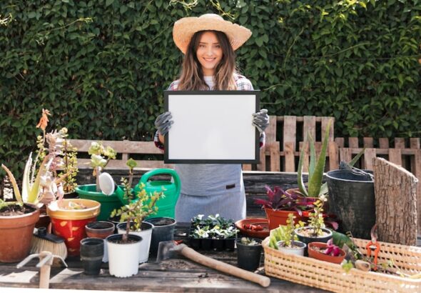 female-gardener-standing-potted-plants-showing-white-frame_23-2148165229