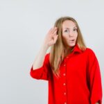 lady-red-shirt-showing-salute-gesture-looking-confident_176474-39784