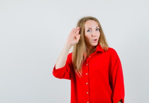 lady-red-shirt-showing-salute-gesture-looking-confident_176474-39784