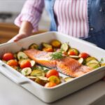 person-is-holding-tray-fish-vegetables_1000124-287317