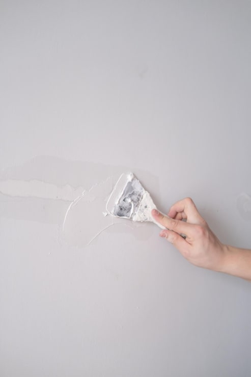 person-is-painting-wall-with-piece-paper-that-says-hand_1315464-597