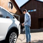 person-taking-care-electric-car_23-2149362794