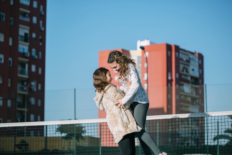 two-girls-playing-rooftop_23-2147814297