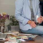 unrecognisable-woman-sitting-messy-desk_23-2148372131