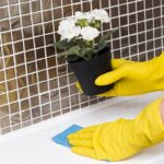 woman-with-rubber-gloves-wiping-sink_23-2148465091