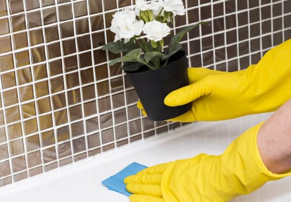 woman-with-rubber-gloves-wiping-sink_23-2148465091