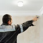 worker-applies-glue-walls-before-wallpapering-primer-walls-idea-renovation-restoration-apartments-selective-focus-brush_166373-2216