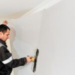worker-attaching-wallpaper-man-is-putting-up-wallpapers-wall-home-renovation-concept_166373-2213