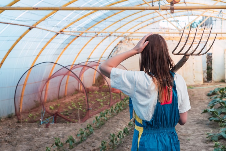 back-view-young-woman-with-grass-raking-tool_181624-39554