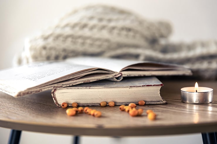 cozy-home-composition-with-books-table-closeup_169016-25844
