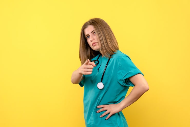 front-view-female-doctor-posing-yellow-space_179666-13531