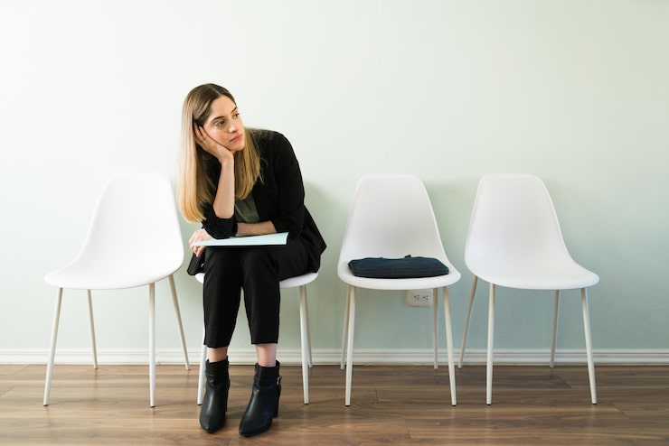 tired-caucasian-woman-professional-suit-feeling-sad-while-waiting-appointment-her-job-interview-recruitment-office_662251-284