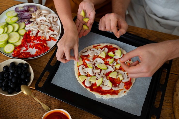 top-view-cook-preparing-pizza_23-2150283022