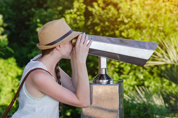 young-woman-looks-through-binoculars-tourists-viewpoint-park-background_134398-21015